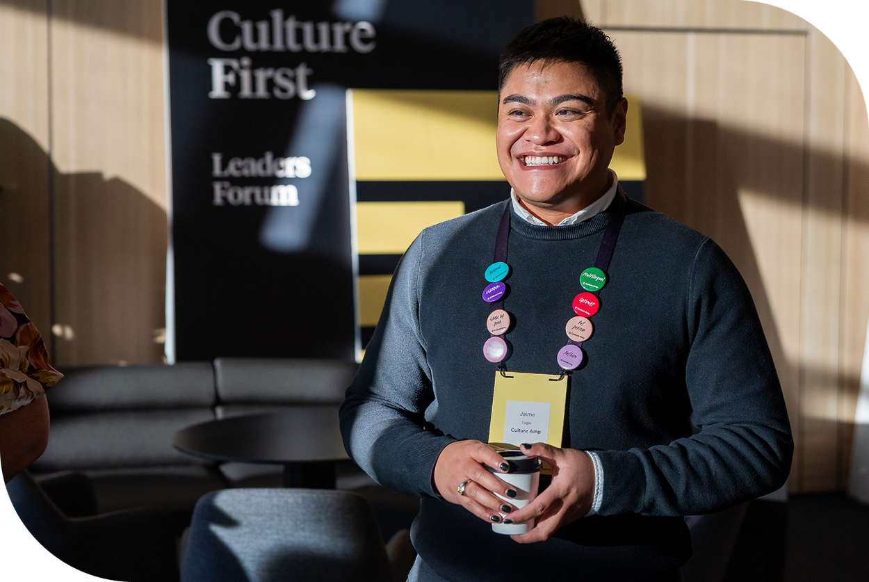 Culture Amp employee wearing belonging badges at Culture First event